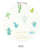 Elevate your beauty routine with the Hello Kitty Sanrio Boutique Collectible Compact Mirror! This charming mirror features the lovable queen Hello Kitty from Sanrio in a popular print by the Japanese boutique brand, Naosudou.
The compact mirror showcases a delightful design with Hello Kitty in a stylish watercolor desert and cactus print, adding a playful yet elegant flair. The high-quality mirror is perfect for on-the-go touch-ups and is housed in a durable, collectible case that’s as cute as it is practi